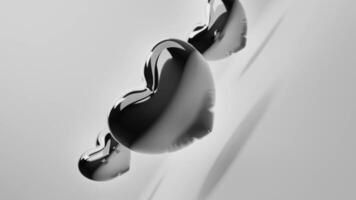 black and white photo of three hearts floating in water video