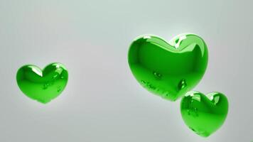 Tres verde corazones flotante en el aire video