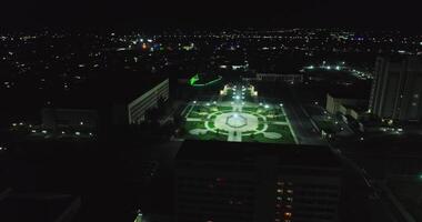 The drone flies over the night illuminated square next to the ancient complex Ark of Bukhara, Uzbekistan. video