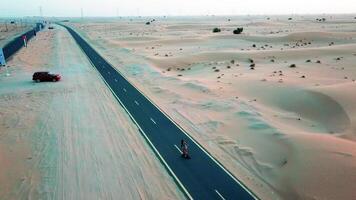 Girl rides on a skateboard on a desert road video