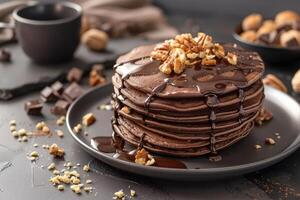 Delicious chocolate pancakes decorated with nuts photo