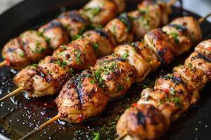 Grilled chicken skewers with bell peppers and onions served on a pan photo