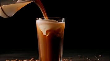 Milk cream is poured into a Iced Coffee with ice cubes on a dark table with coffee beans animation. High quality 4k footage video