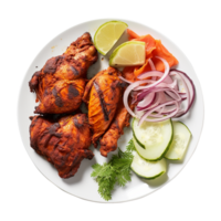 Tasty tandoori chicken plate with vegetable and lime slices on transparent background png