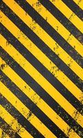 Realistic wallpaper of warning tape stripes. Black yellow caution grunge background vector