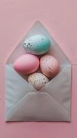 A creative presentation of Easter eggs in various hues neatly tucked inside a paper envelope photo