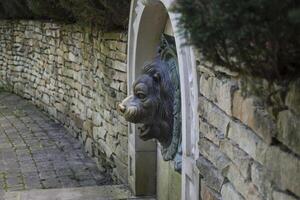 Old stone fountain with lion statue. photo