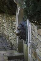 Old stone fountain with lion statue. photo