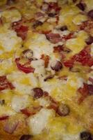 Pizza with salami and cheese, close up. photo