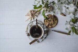 A cup of coffee and blossom branches. Spring morning. photo