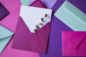 The pink envelope with note blank on a colorful background. photo