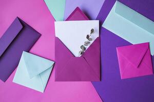 The pink envelope with note blank on a colorful background. photo