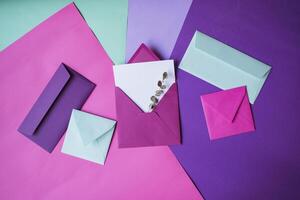 The pink envelope with note blank on a colorful background. photo