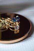 Golden ring with diamonds. Female jewelry on a table, close up. photo