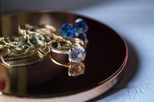 Golden ring with diamonds. Female jewelry on a table, close up. photo