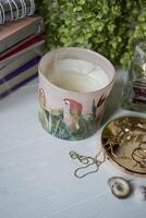 Put out candle with smoke. Home decor and female accessories on a table, close up. photo