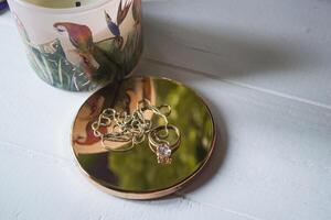 Golden ring with diamonds. Female jewelry on a table, close up. photo