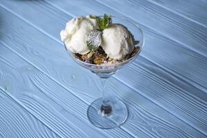 Ice cream on a blue wooden table. photo