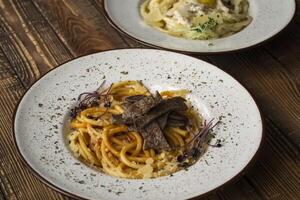 Italian pasta on a wooden table. photo