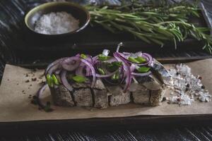 The sandwich with herring fish and onion. photo