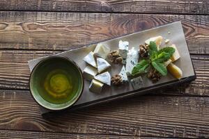 Cheese plate on a wooden table. photo