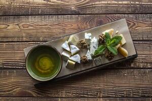 Cheese plate on a wooden table. photo