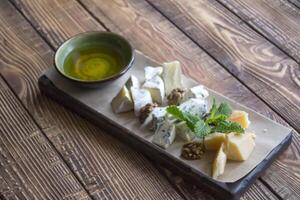 Cheese plate on a wooden table. photo