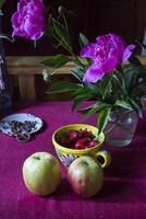 Apples and srawberry on the kitchen table. photo