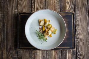 Cream soup in a plate, on a wooden table. photo