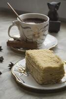 A cup of coffee and cake on a desk. Morning breakfast. photo