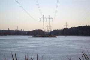 Electric towers on a island on the lake. photo