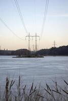 Electric towers on a island on the lake. photo