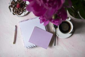 Coffee, empty paper and peony. Background with place for text. photo