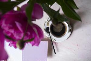 Coffee, empty paper and peony. Background with place for text. photo