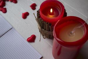 Red candles and love hearts on the table, close up. photo