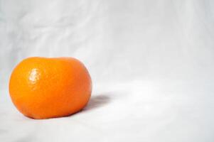 A small orange on a white background photo