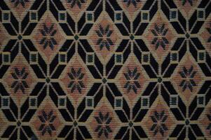 A patterned carpet with a black and brown color scheme photo