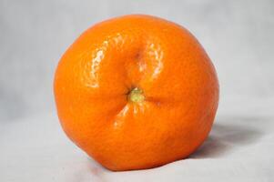 A large orange on a white background photo