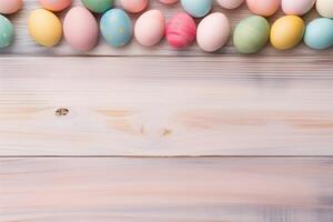 Easter holiday celebration banner greeting card with pastel painted eggs on bright wooden tabel texture photo