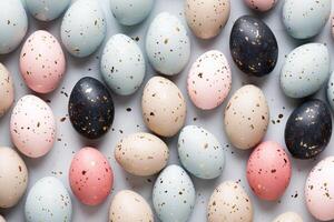 Pastel colored easter eggs speckled and painted with gold, top down view flatlay background photo