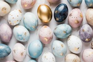 Pastel colored easter eggs speckled and painted with gold, top down view flatlay background photo