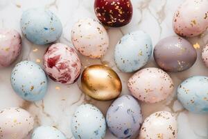 Pastel colored easter eggs speckled and painted with gold, top down view flatlay background photo