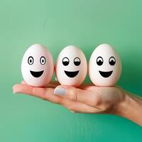 Easter diet concept hand holds three eggs with amusing faces For Social Media Post Size photo