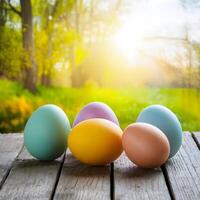 Easter eggs on wooden table against spring landscape, copy space For Social Media Post Size photo