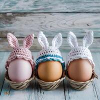 Easter eggs wear crochet hats with bunny ears on shabby background For Social Media Post Size photo