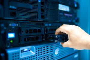 IT engineer repairing a server in a datacenter photo