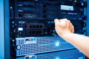 IT engineer repairing a server in a datacenter photo