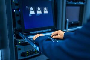 IT engineer repairing a server in a datacenter photo