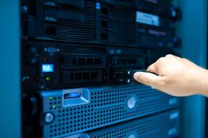 IT engineer repairing a server in a datacenter photo