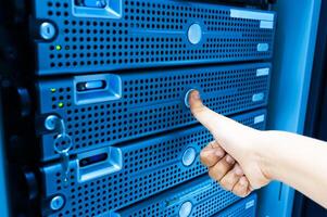 IT engineer repairing a server in a datacenter photo